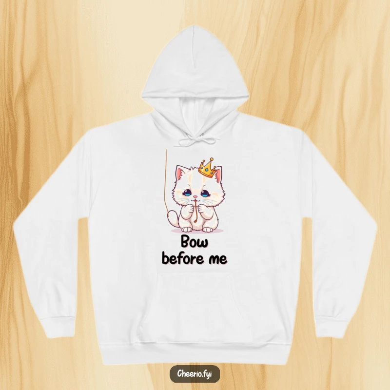 Funny Hoodie: A fluffy cat wearing a crown, playfully batting a string, offering cozy comfort and feline humor.