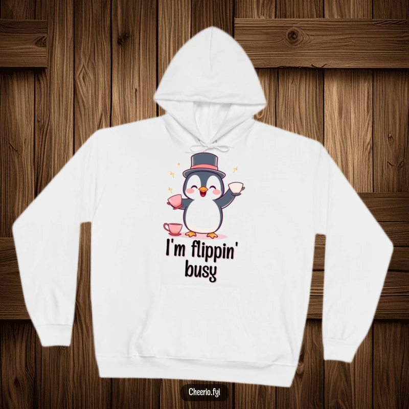 Funny Penguin Juggling Hoodie: A delighted penguin in a bowler hat juggles teacups, offering cozy, whimsical charm.