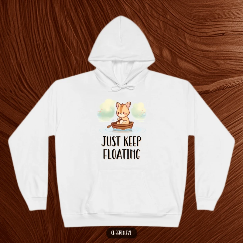 Funny British animal character rowing a small boat on a tranquil river, designed for a cozy hoodie, offering humorous warmth.