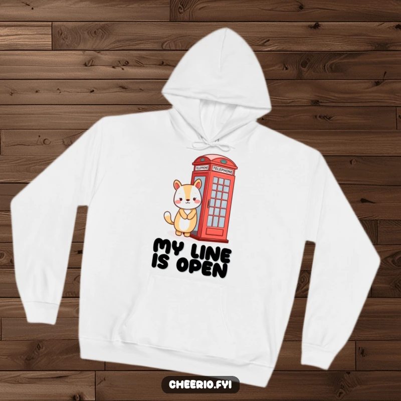 Funny hoodie with a smiling animal character standing near a classic red telephone booth, exuding friendliness.