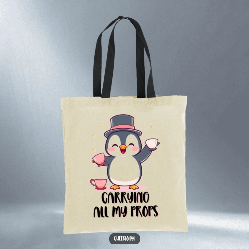 Funny Penguin Juggling Tote Bag: A delighted penguin wearing a bowler hat juggles teacups, perfect for carrying whimsy.